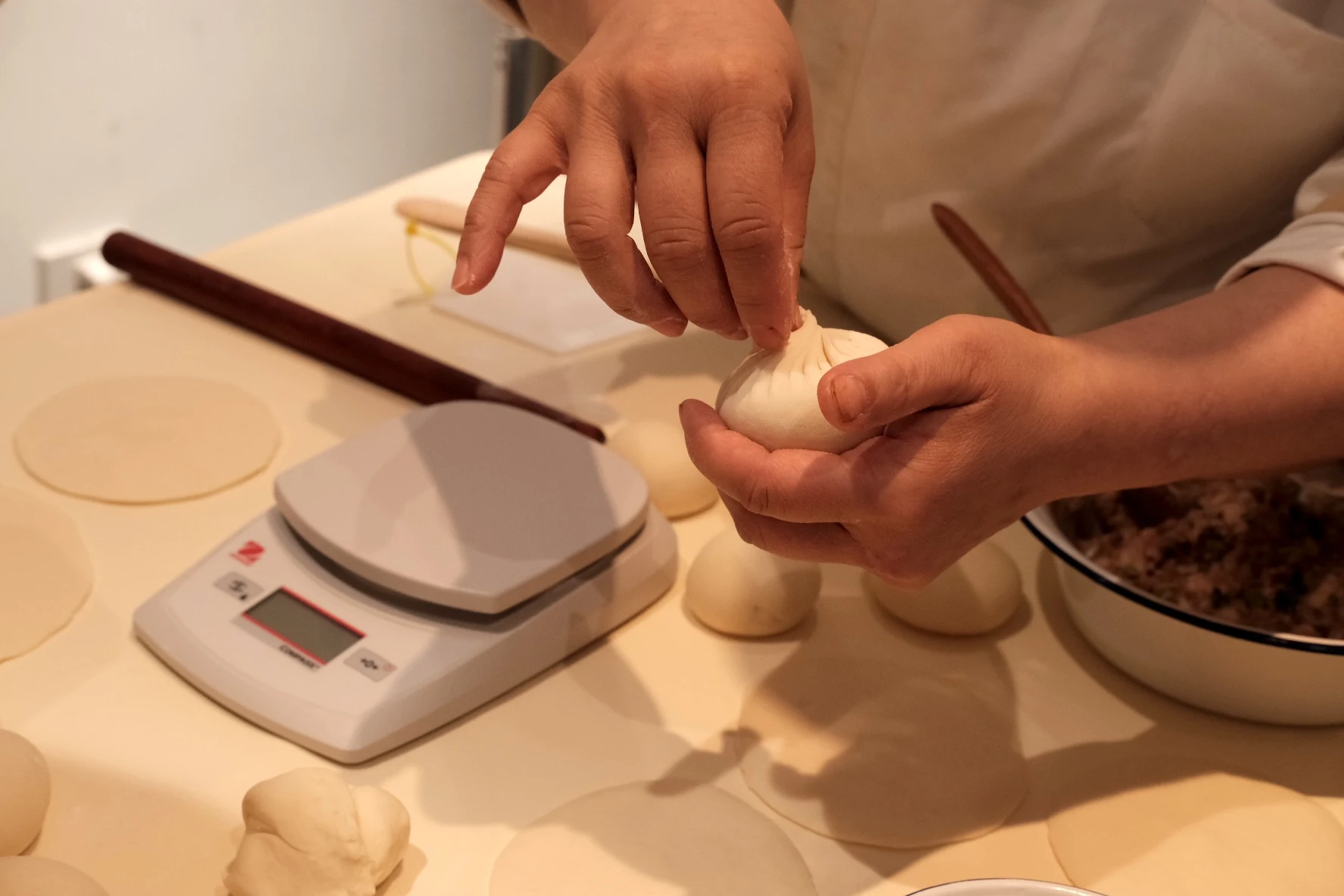 Hands making bao